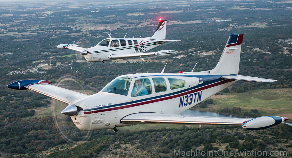 Beechclub's two turbo-normalized Bonanzas, N33TN and N17826, flying in formation over the Texas Hill Country